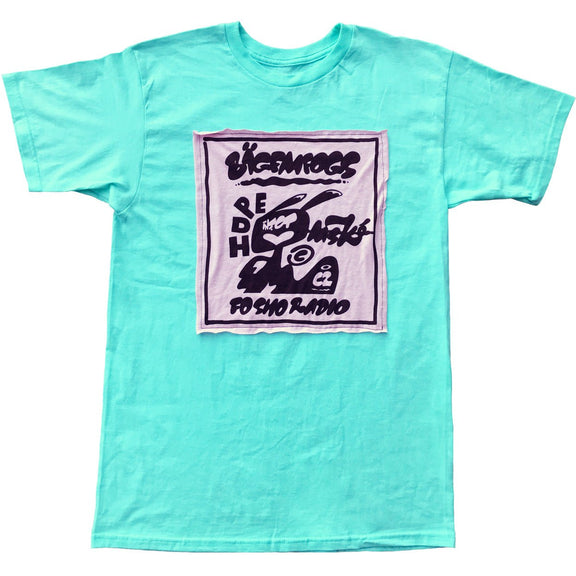 Black print of a cat patch sewn on a teal SS t-shirt.