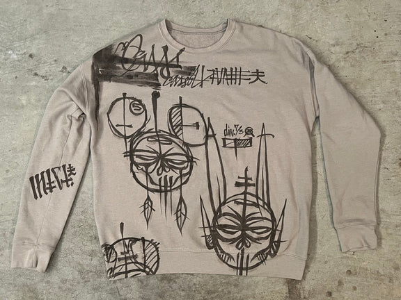 Black painted characters on a white sweatshirt.