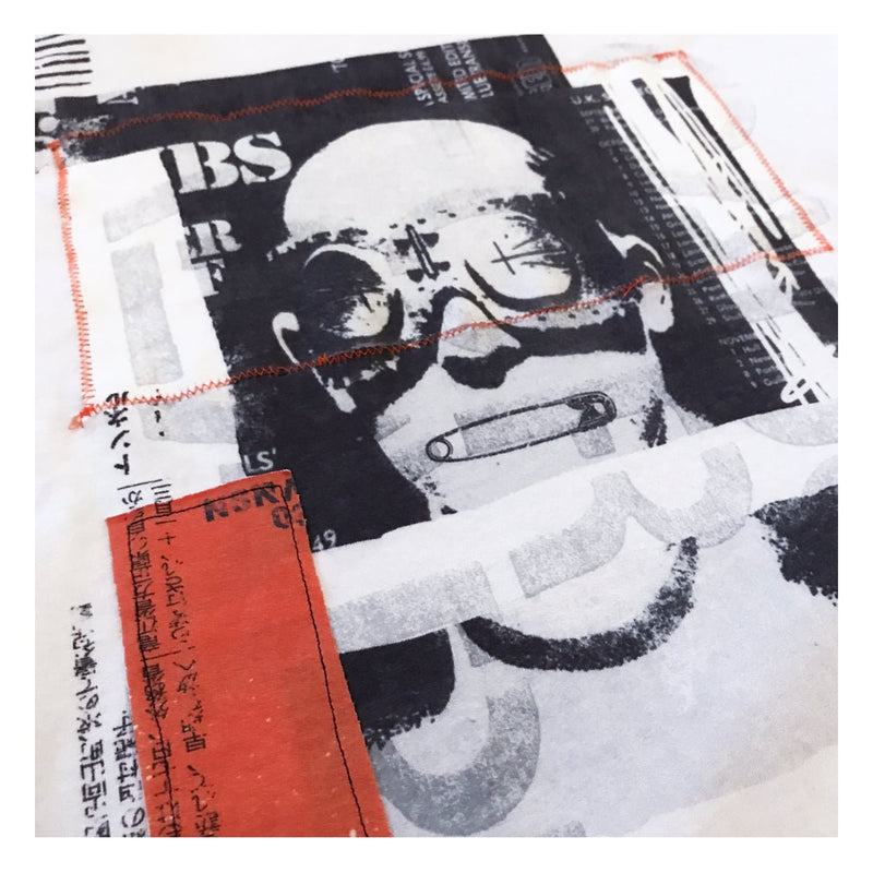 Blown up image of hand stitched patches and print.